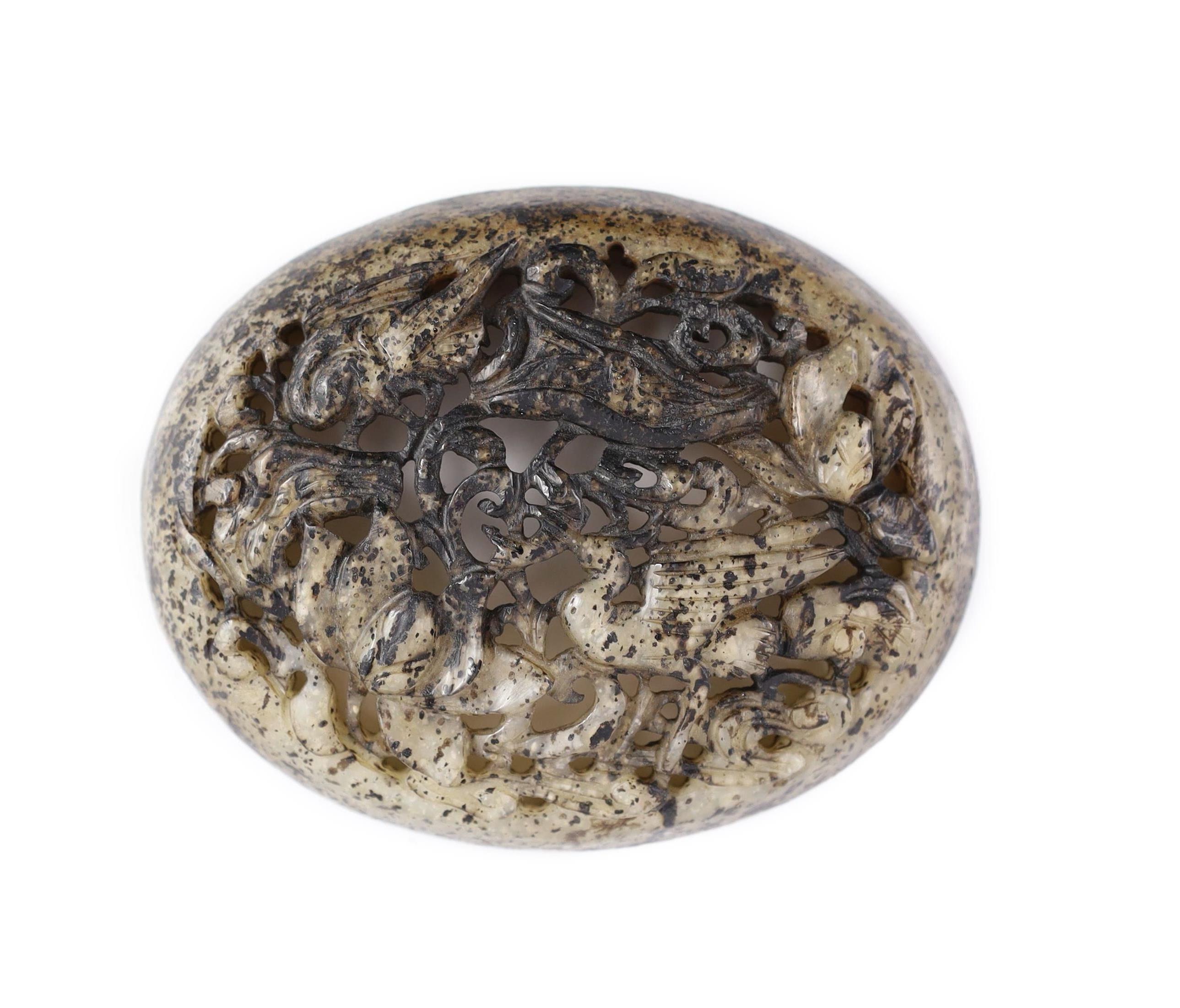 A Chinese pale grey and black jade oval plaque, Yuan dynasty or later, 11cm wide